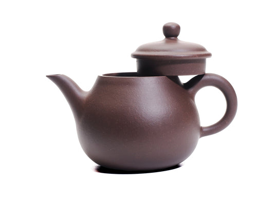 Da Ming Yuan Luo Han teapot with lid removed and resting on the handle, revealing the wide mouth and elegant profile.