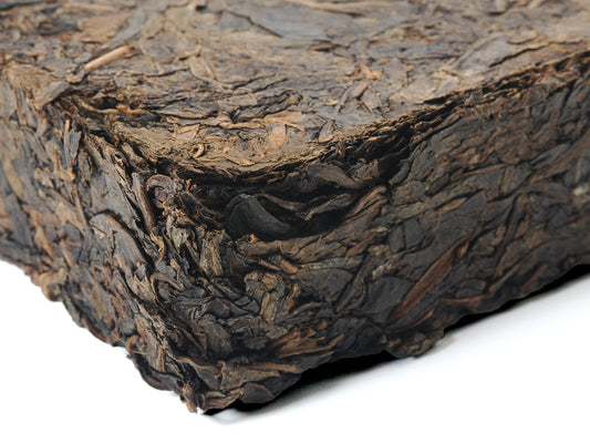 Close-up side view of Fu Brick Tea (茯砖茶) showing compressed leaf texture – traditional dark tea by Cha Zhi Ji and Hui He Tang