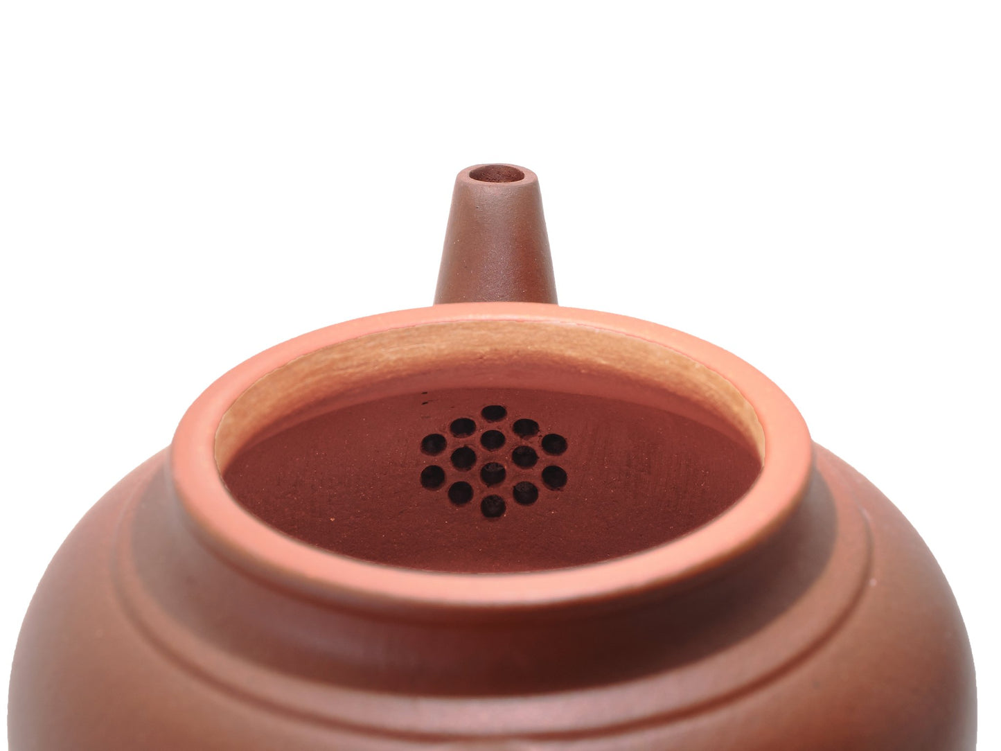 Close‑up of the teapot’s interior showing the built‑in multi‑hole filter near the spout for clean pouring.