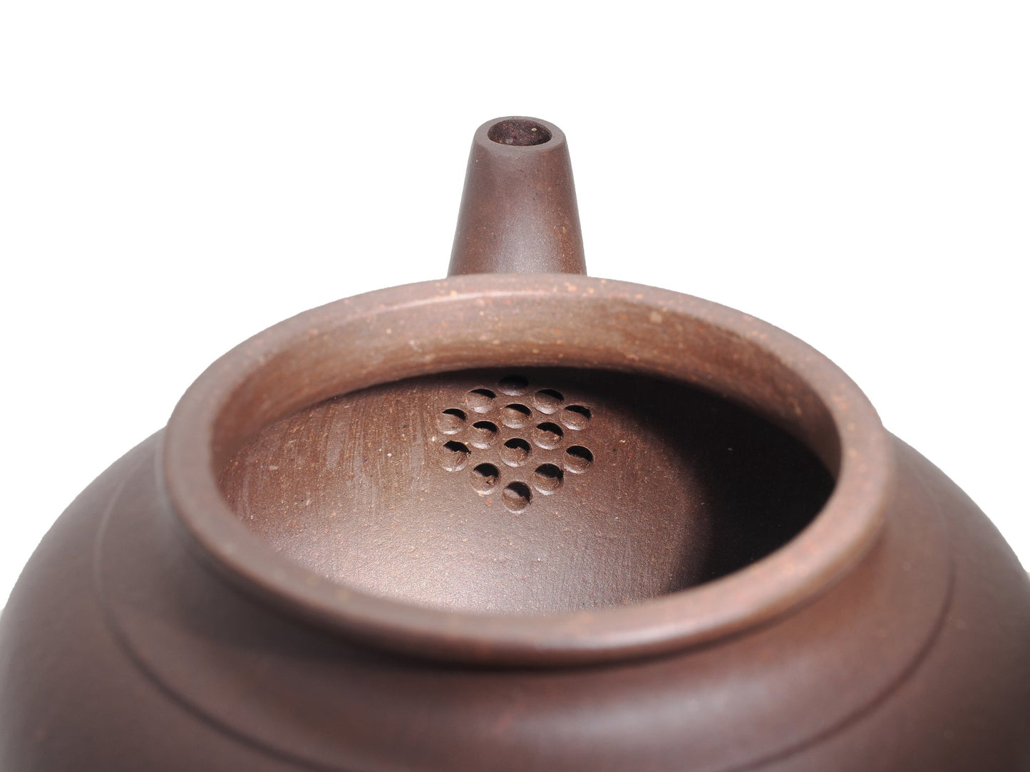 Close‑up of the Xiao Ying teapot’s interior with a built‑in multi‑hole filter near the spout for smooth pouring.