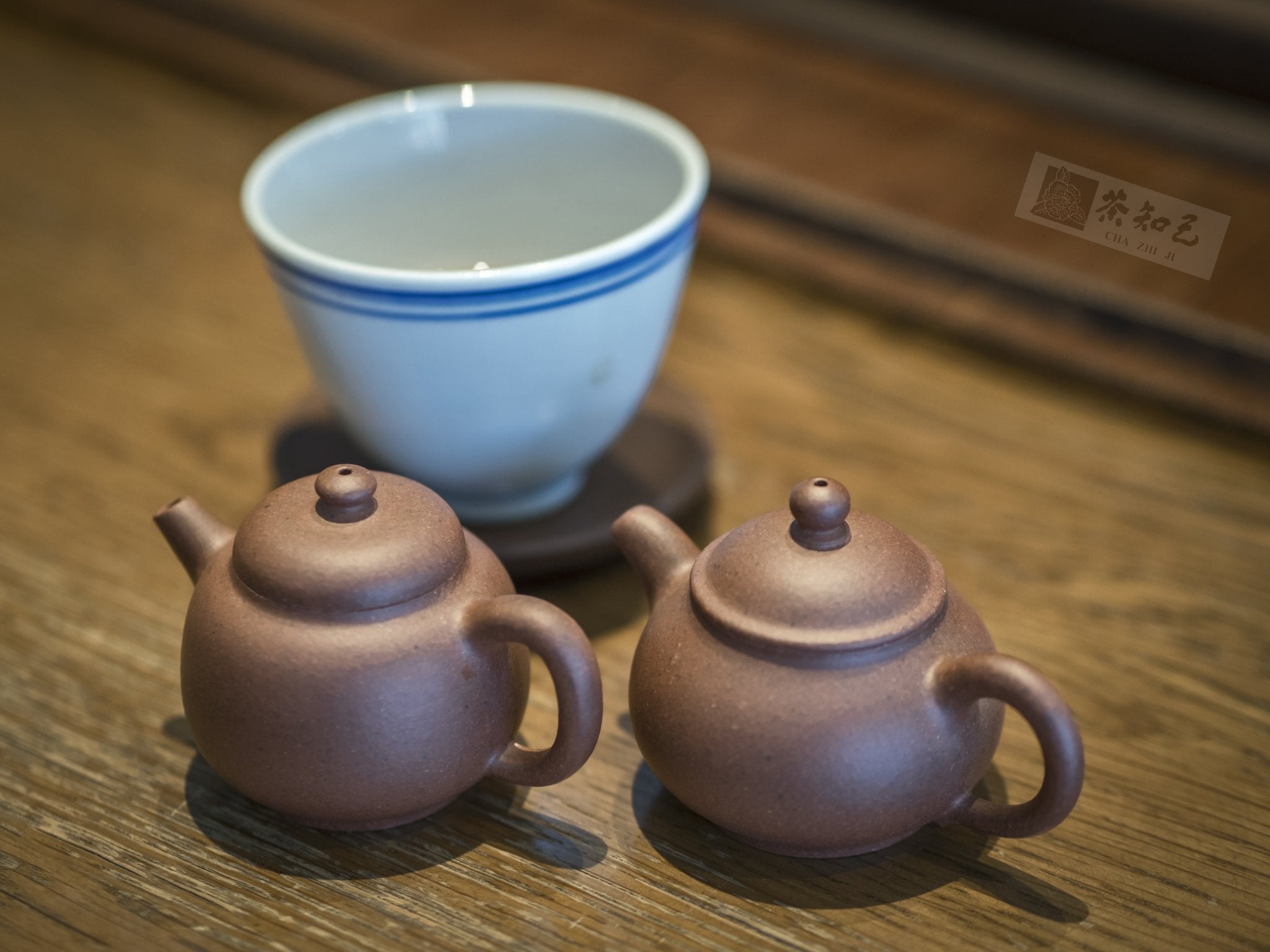New arrivals at Cha Zhi Ji – featuring Yixing teapots and blue line Jingdezhen teacup on wooden tea table