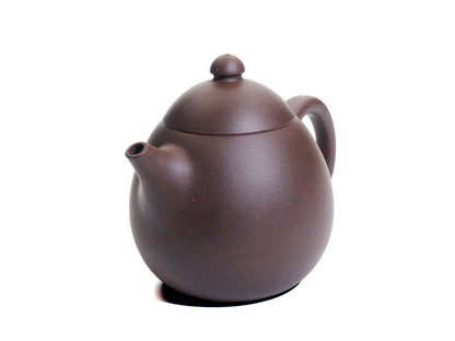 Angled front‑right view of the Da Long Dan Yixing teapot displaying its smooth rounded body, short spout and small domed lid.