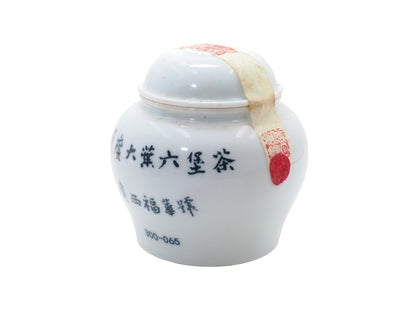 Sealed porcelain jar of Fuhua Liu Bao Tea from 1950s with red wax seal and Guangxi markings