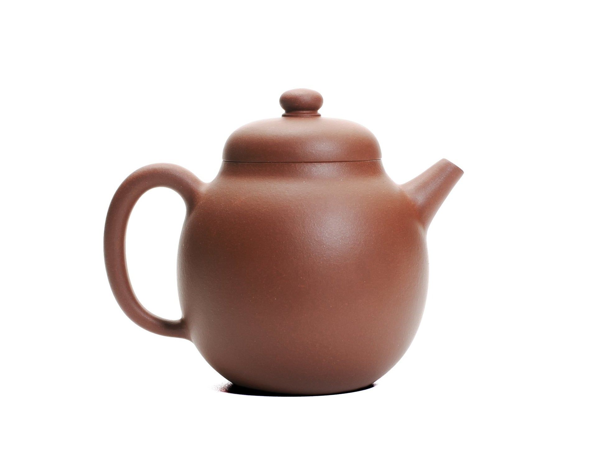 Right side view of the Hong Pi Long Da Long Dan teapot with the curved spout pointing right and the large handle on the left.