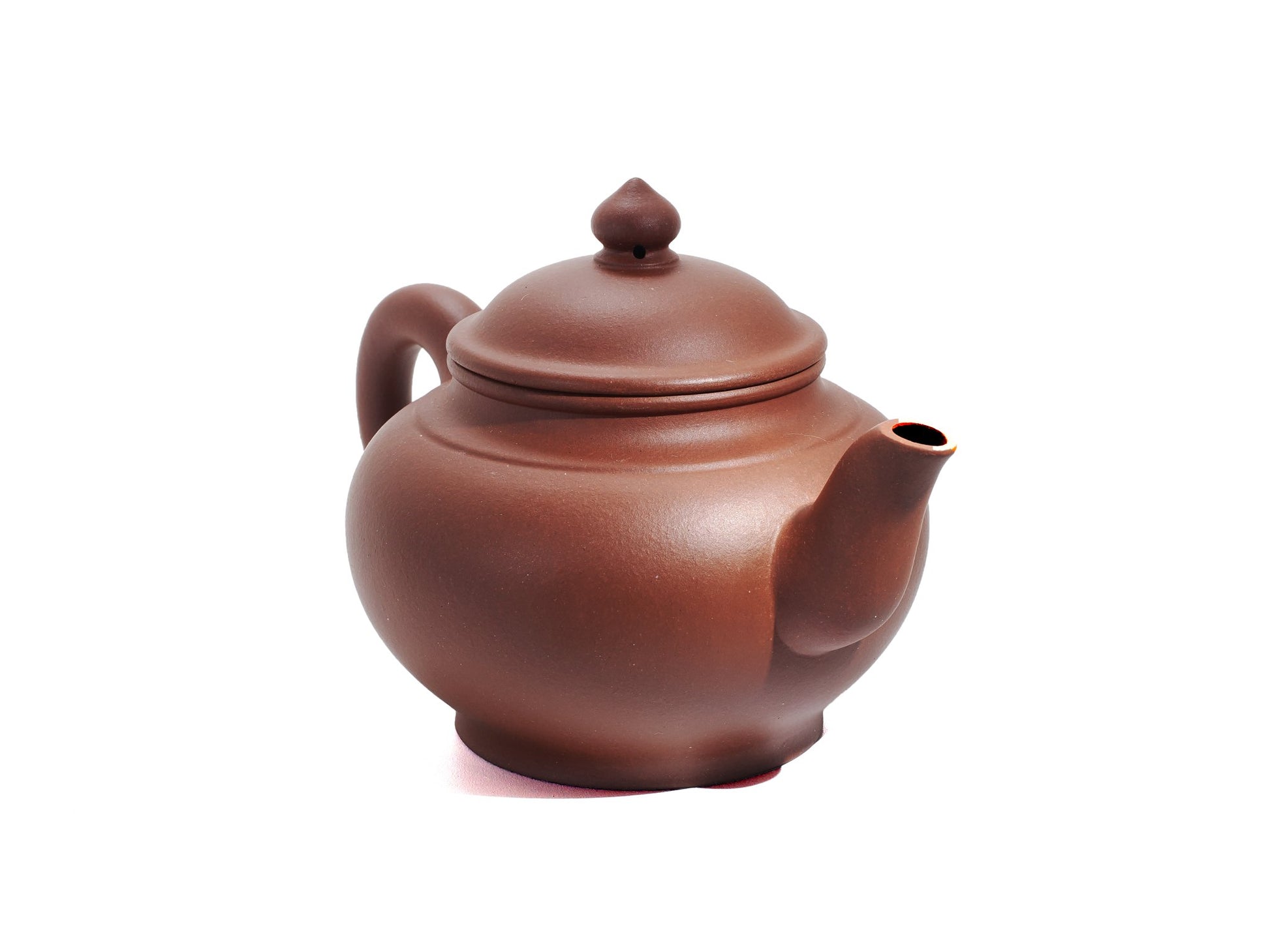 Angled front‑right view of the Xiao Ying Hu teapot displaying its round belly, pointed spout and smoothly polished red clay surface.