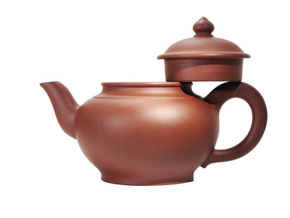 Side view of the Zhao Zhuang Hong Ni Xiao Ying Hu teapot with the lid removed and resting on the handle, highlighting the wide mouth and curved spout.