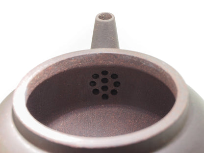 Close-up of the internal filter holes inside the Jade Grade teapot, showing the clean and precise clay work.