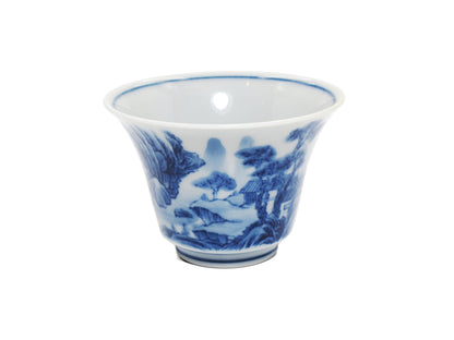 Angled view of hand-painted landscape on modern porcelain teacup