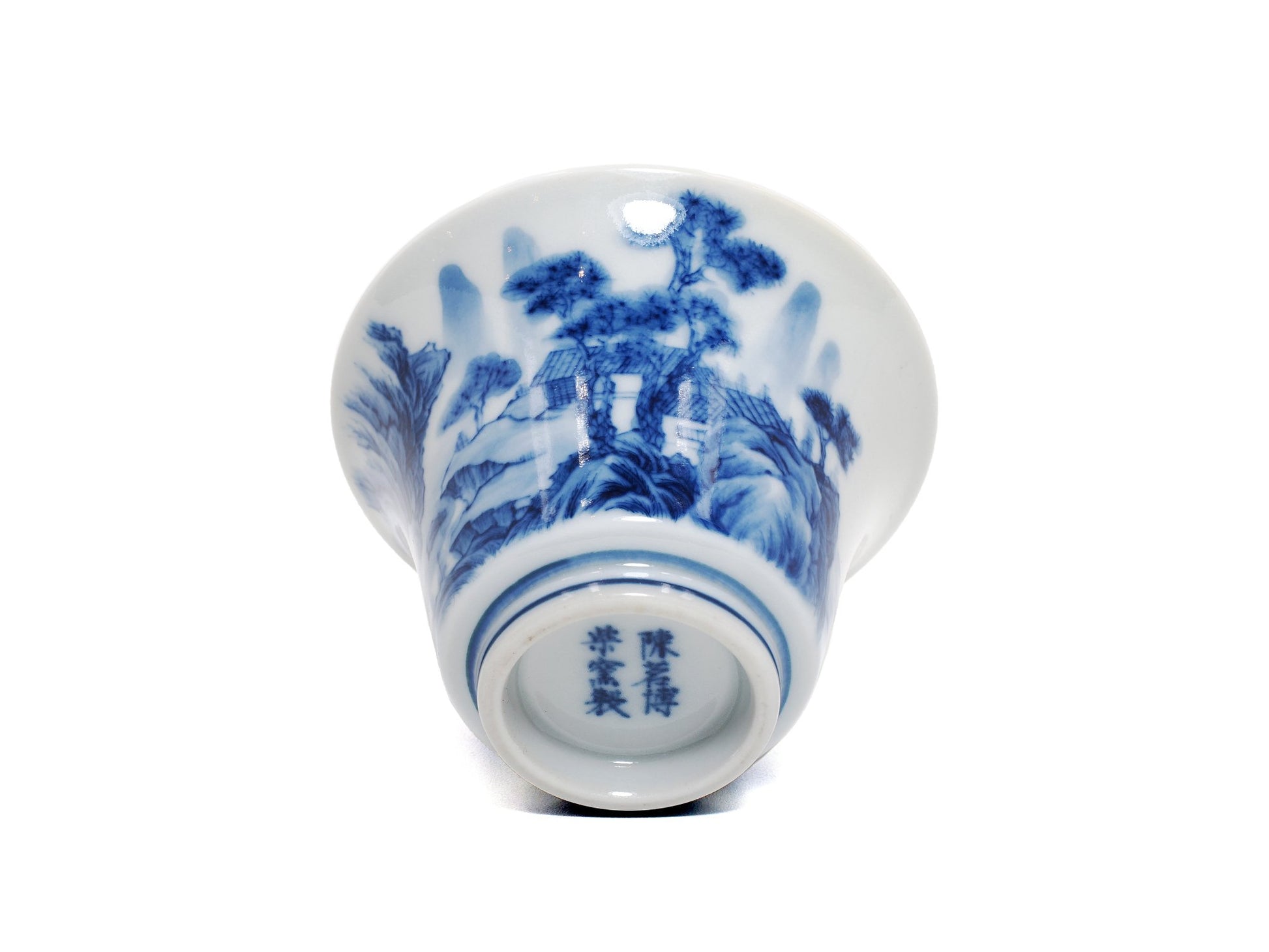 Base of landscape teacup showing artist signature in blue glaze