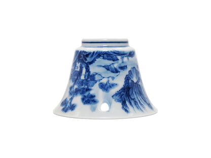 Upside down view of blue and white landscape teacup with wood kiln finish