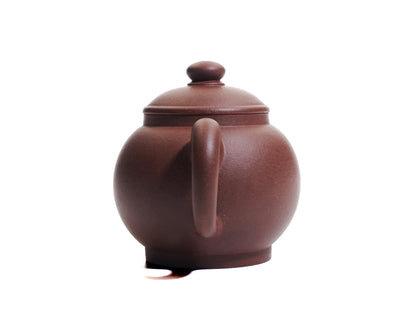Back view of the Ju Lun Zhu teapot highlighting the curved handle and smooth clay surface.