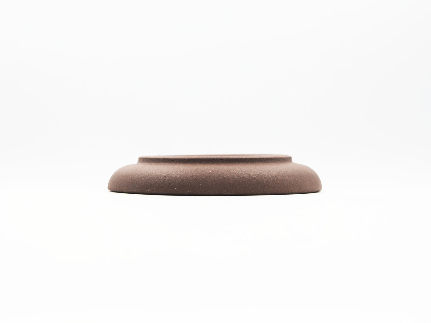 Elevated base view of special grade Lao Zini tea coaster with smooth curve
