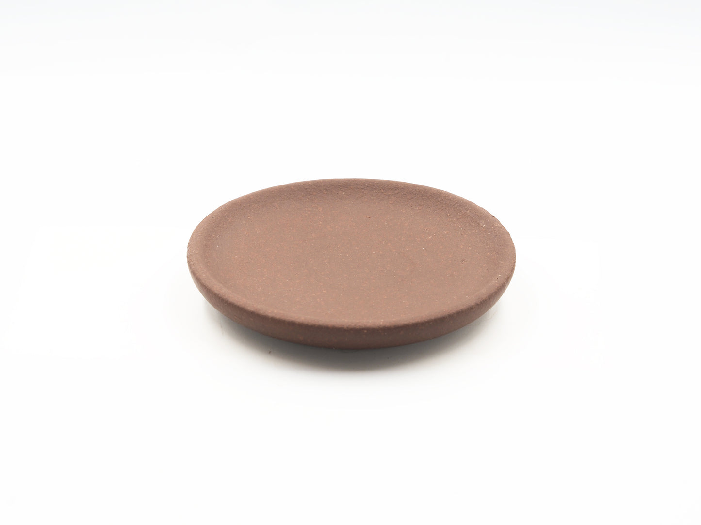 Top view of Lao Zini Dehou tea coaster in round minimalist design