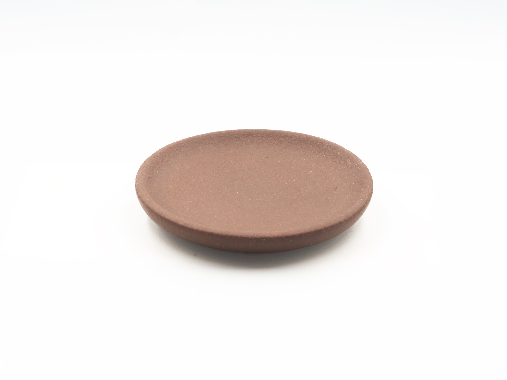 Top view of Lao Zini Dehou tea coaster in round minimalist design