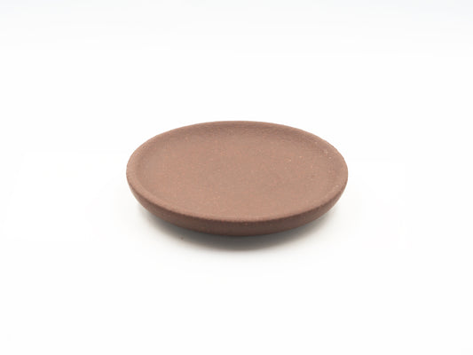 Top view of Lao Zini Dehou tea coaster in round minimalist design