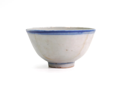 Front view of an antique Late Qing Dynasty Blue Line cup with double blue rim lines, blue foot band and visible hairline age marks