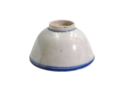 Upturned antique Late Qing Dynasty Blue Line cup showing the foot ring, blue base bands and visible age lines in the glaze