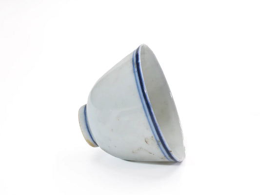 Tilted side view of an antique large Late Qing Dynasty Blue Line cup showing the double cobalt-blue rim lines and pale glazed interior