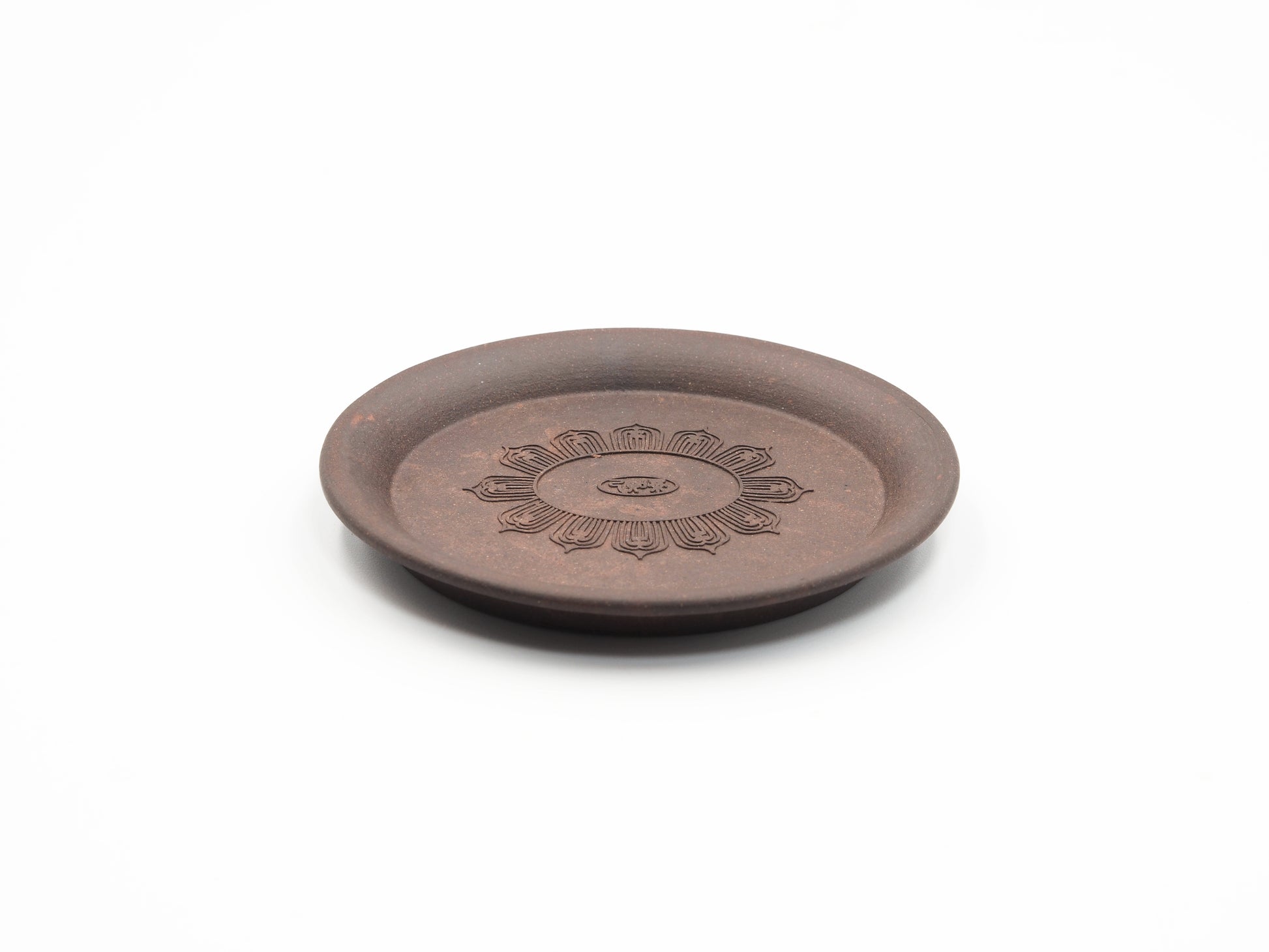 Angled view highlighting the floral engraving on the Yixing tea coaster