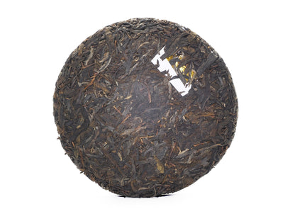 Unwrapped tea cake front with embedded ticket (neifei)