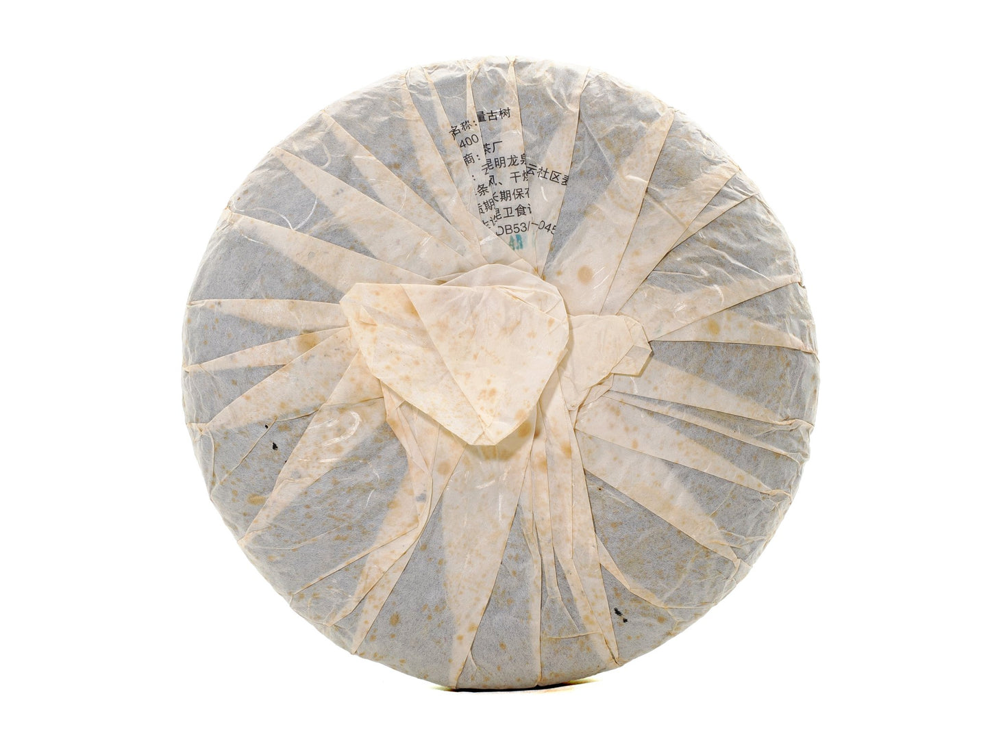 Back view of wrapped 2008 Wuliang Gushu Pu-erh Tea Cake showing traditional folded paper wrapping