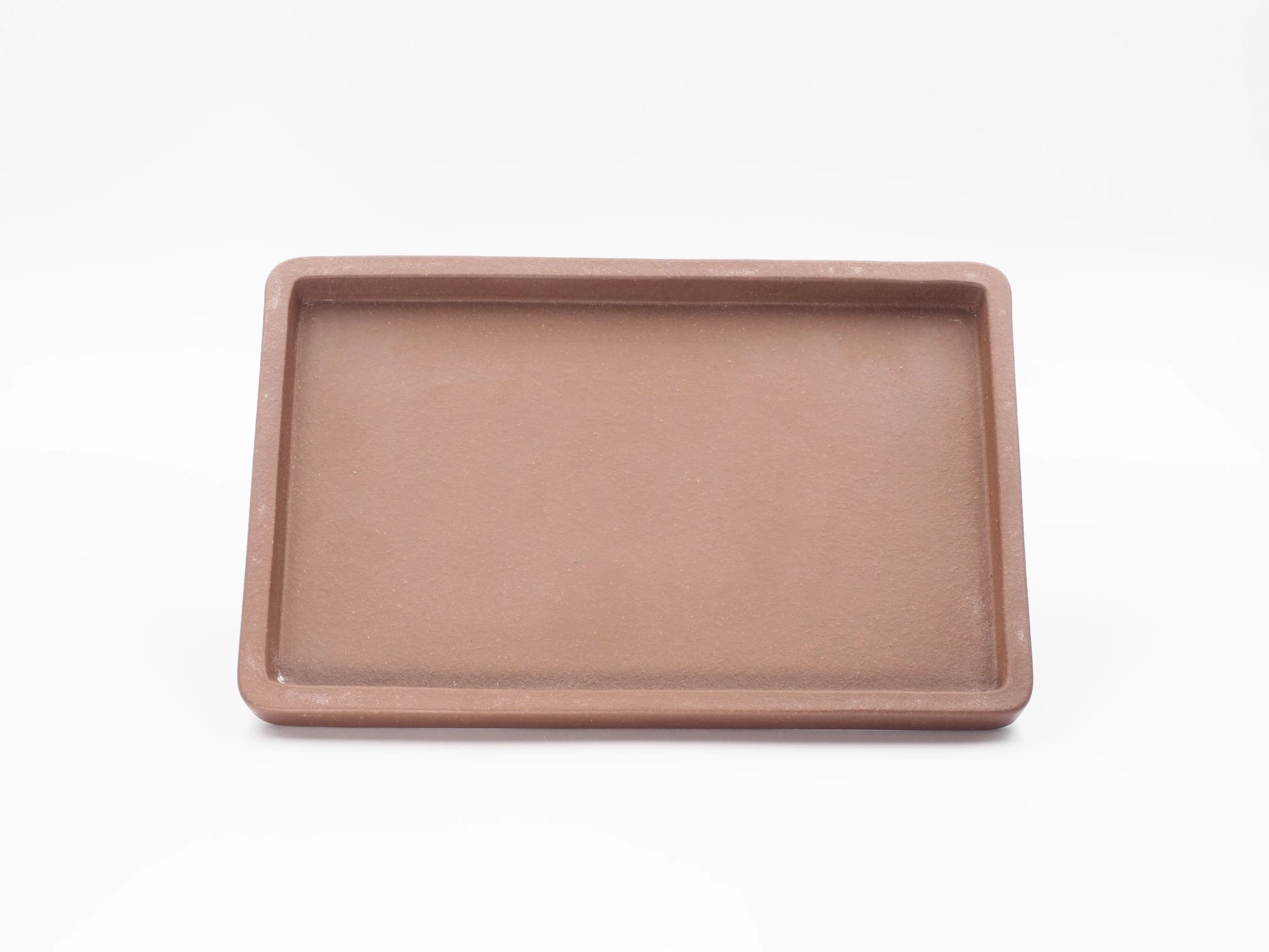 Top-down view of the rectangular Yixing clay tea tray showing its shallow basin