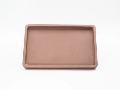 Top-down view of the rectangular Yixing clay tea tray showing its shallow basin