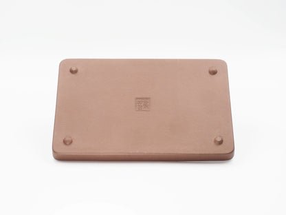 Underside of the Yixing clay tea tray showing the artisan's seal stamp and feet