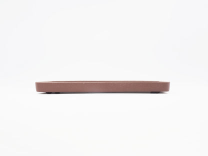 Side profile of the Yixing clay tea tray showing its low, thin form