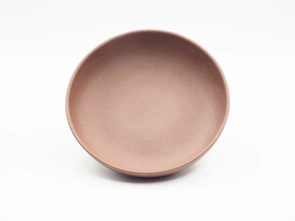 Top-down view of the round Yixing clay tea boat showing its shallow basin