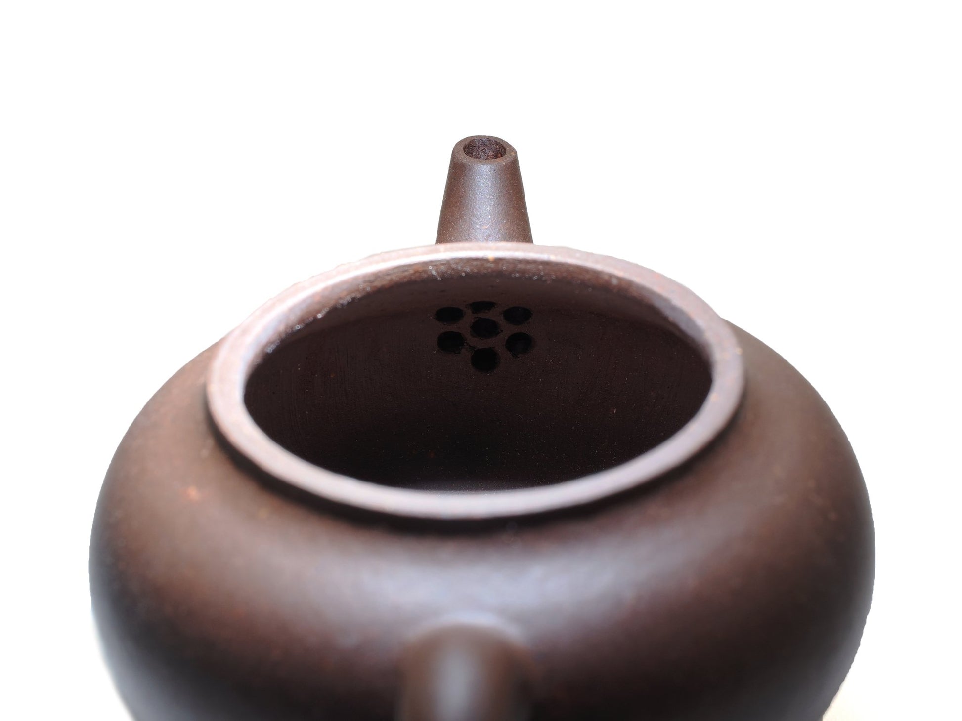 Interior filter holes of Cha Zhi Ji Yixing teapot Junde in bronze grade purple clay