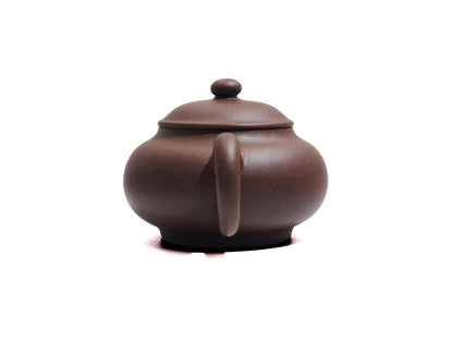 Back handle view of Cha Zhi Ji Junde Yixing teapot in bronze grade purple clay