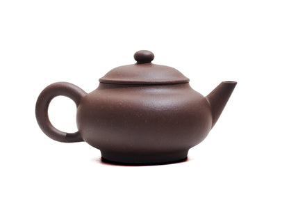 Left side view of Cha Zhi Ji Yixing teapot Junde in bronze grade purple clay