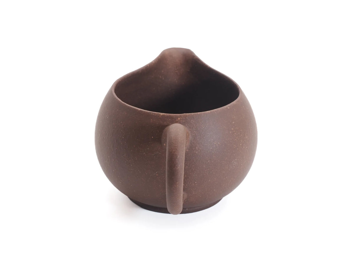 Yixing zisha cha hai fairness pitcher, three-quarter front view in unglazed purple clay