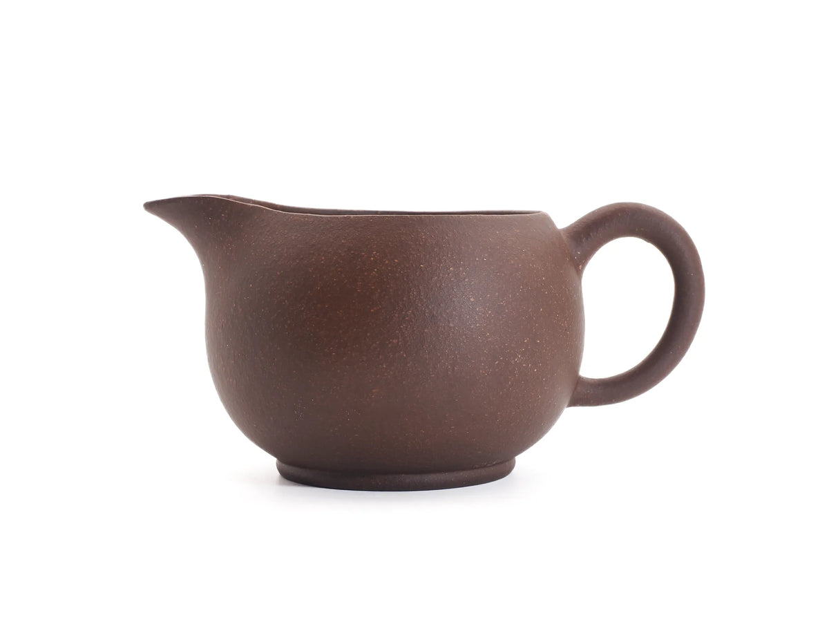 Yixing zisha fairness pitcher side profile showing the rounded spout and ring handle