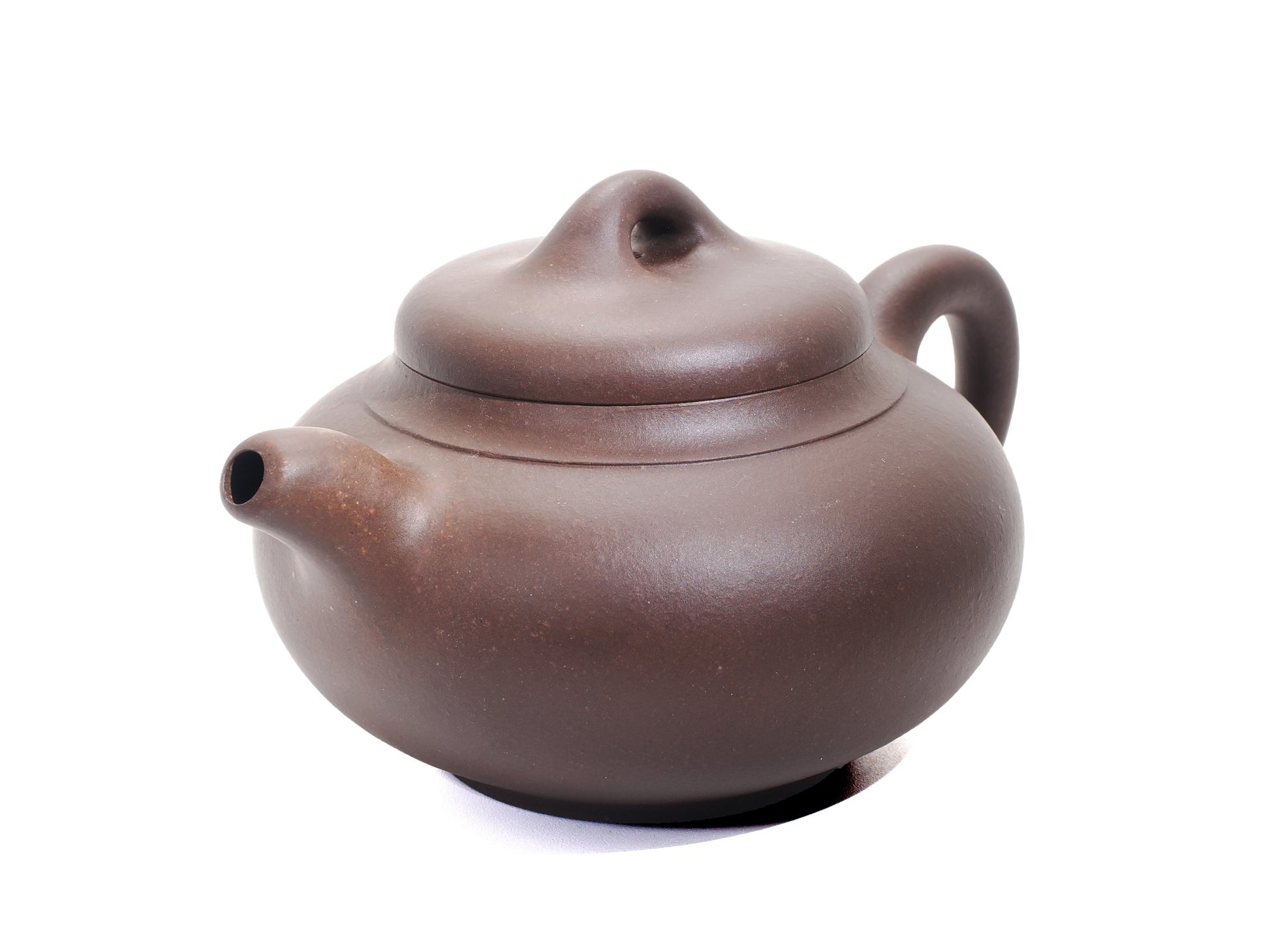Angled front‑right view of the Yun Tong Hu teapot showing its dark brown bronze‑grade clay and short spout.